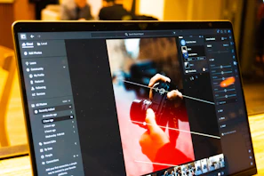 Photo editing software is shown on a laptop screen.