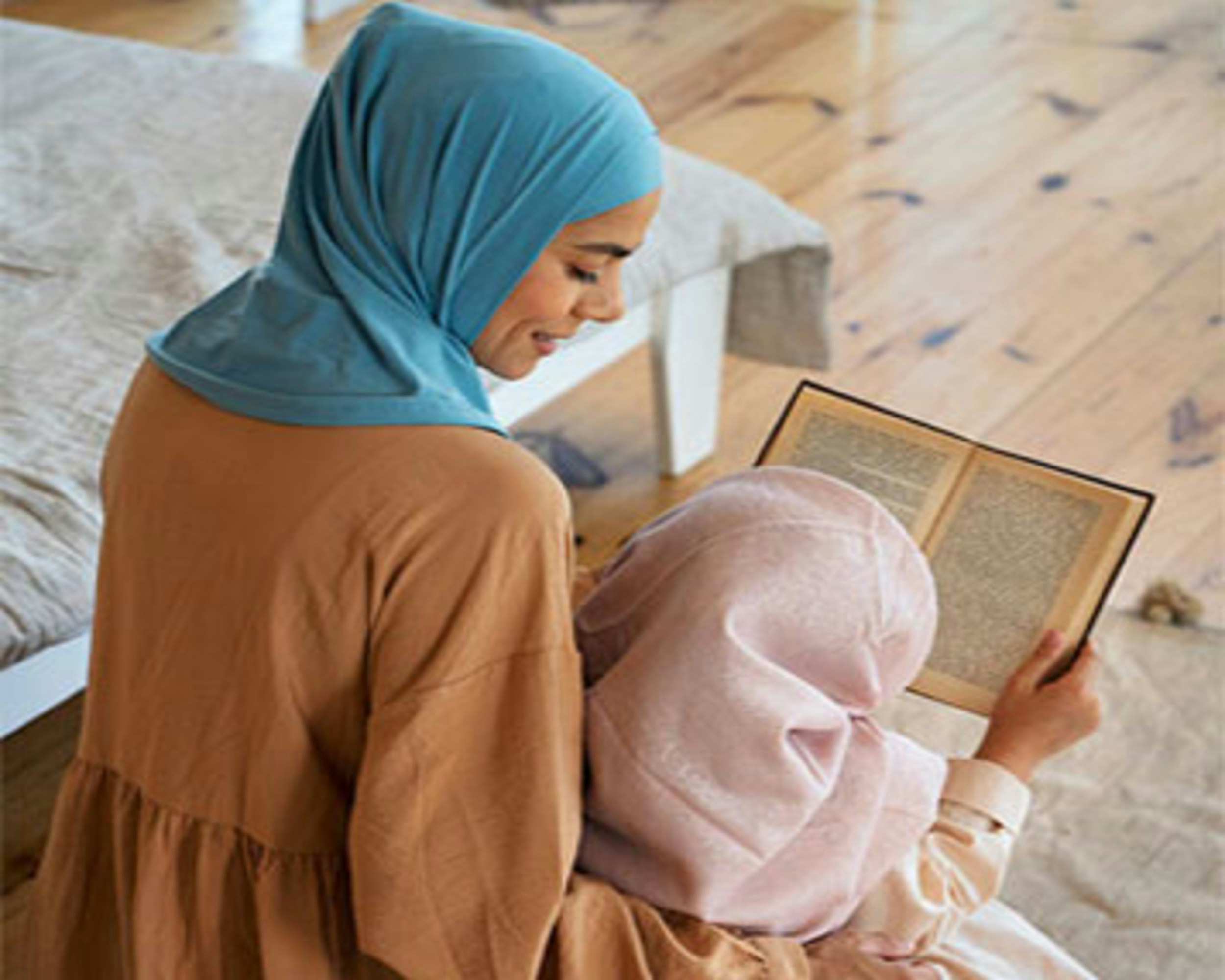 Woman and child reading a book together.