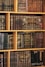 Bookshelf filled with beautifully bound, aged books.