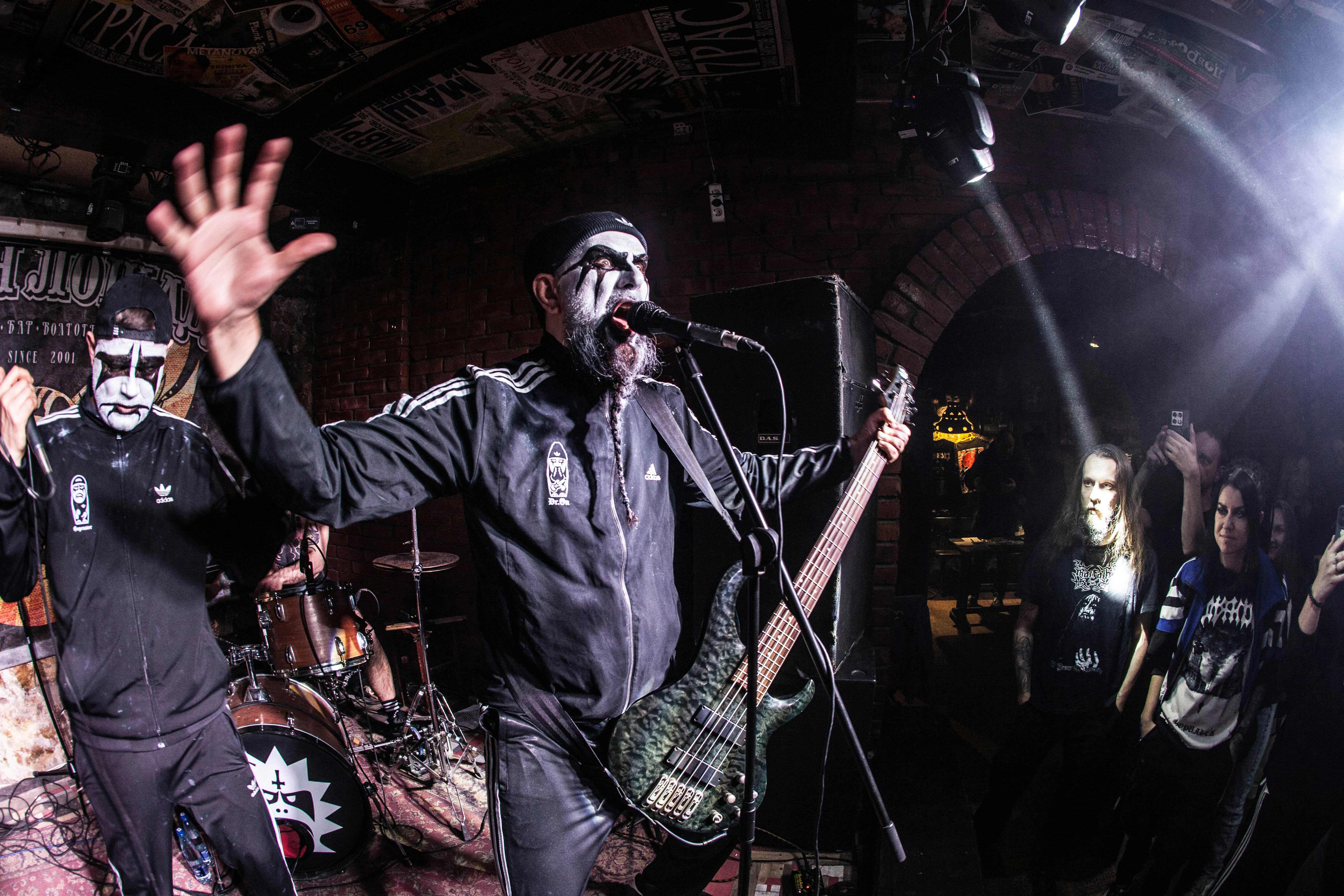 A band performs on stage with intense energy.