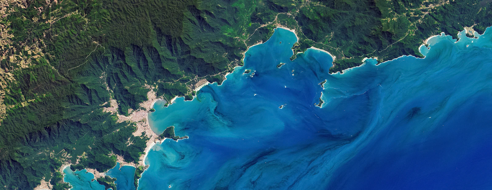 Satellite view of a rugged coastline with turquoise water