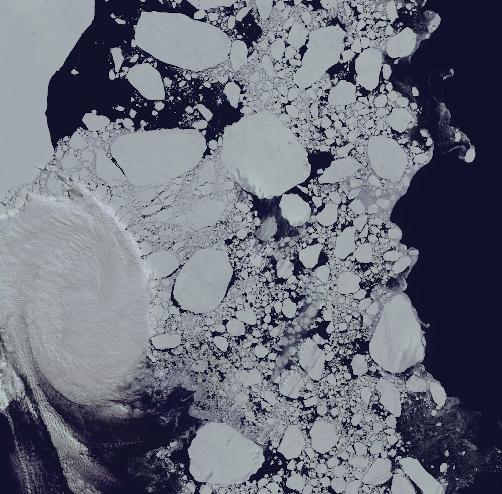 Satellite view of floating ice in dark water