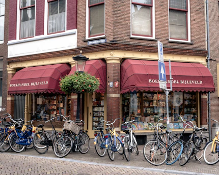 A bookstore with bicycles parked out front.