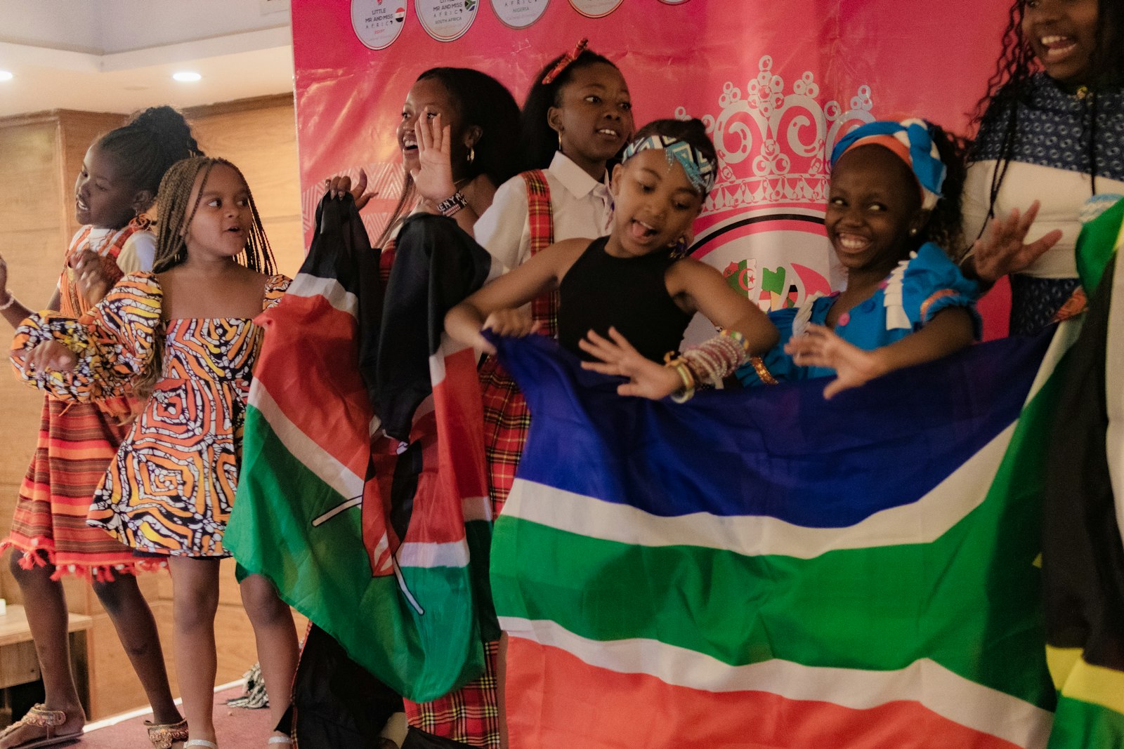 Young girls celebrating together, holding flags