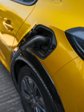 An electric car is charging at a station.