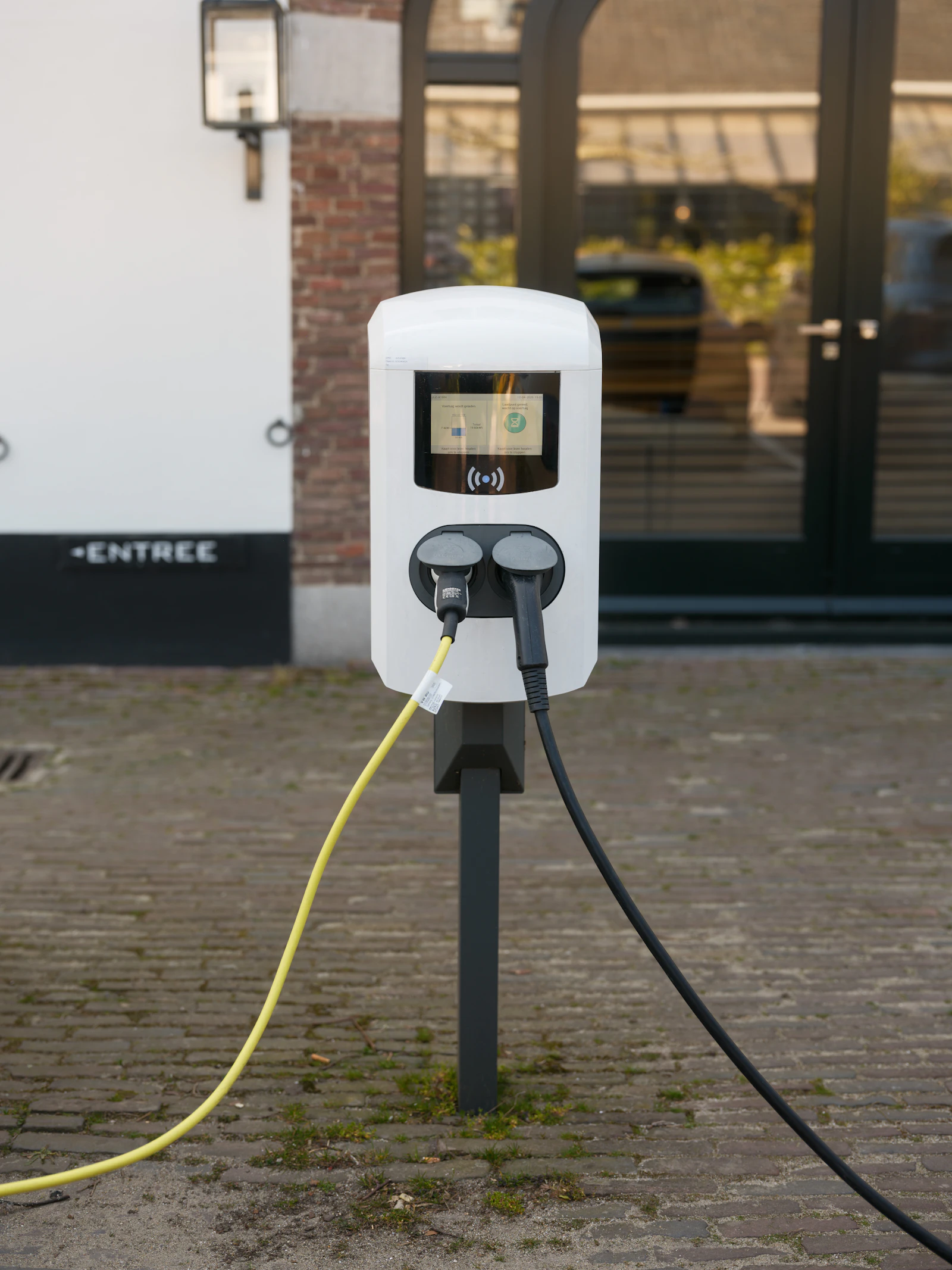An electric vehicle travels through a mountain landscape
