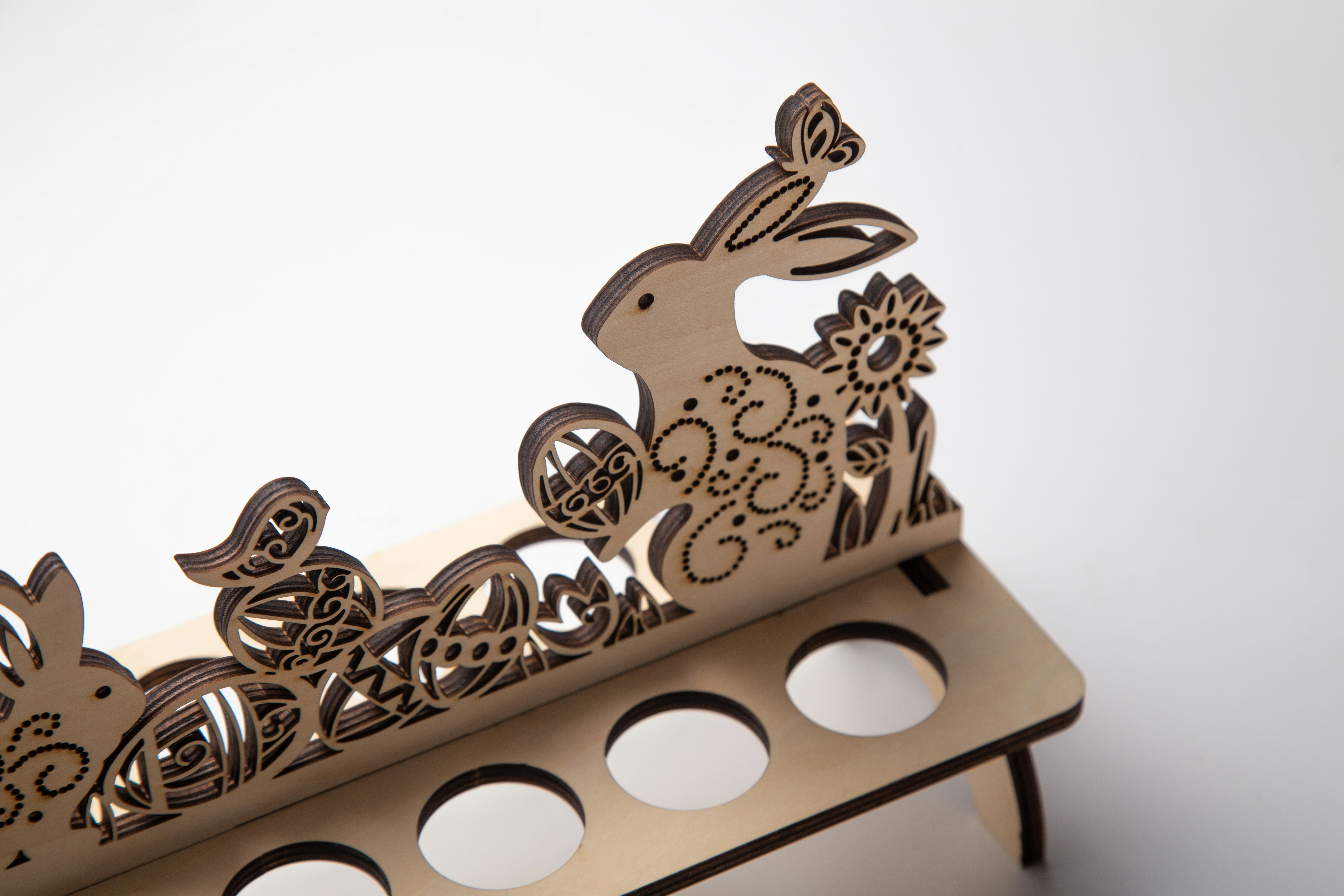 Easter egg holder with bunny and floral details.
