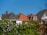 Roofs of houses with a clear blue sky.