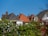Roofs of houses with a clear blue sky.