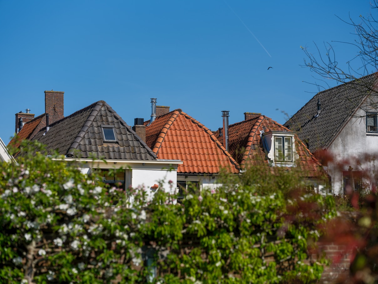 Roofs of houses with a clear blue sky.