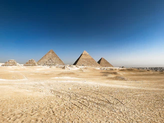 Pyramids of giza stand tall in the desert.