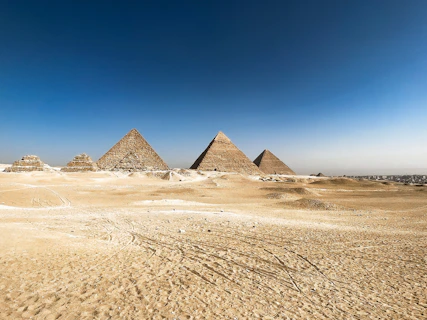 Pyramids of giza stand tall in the desert.