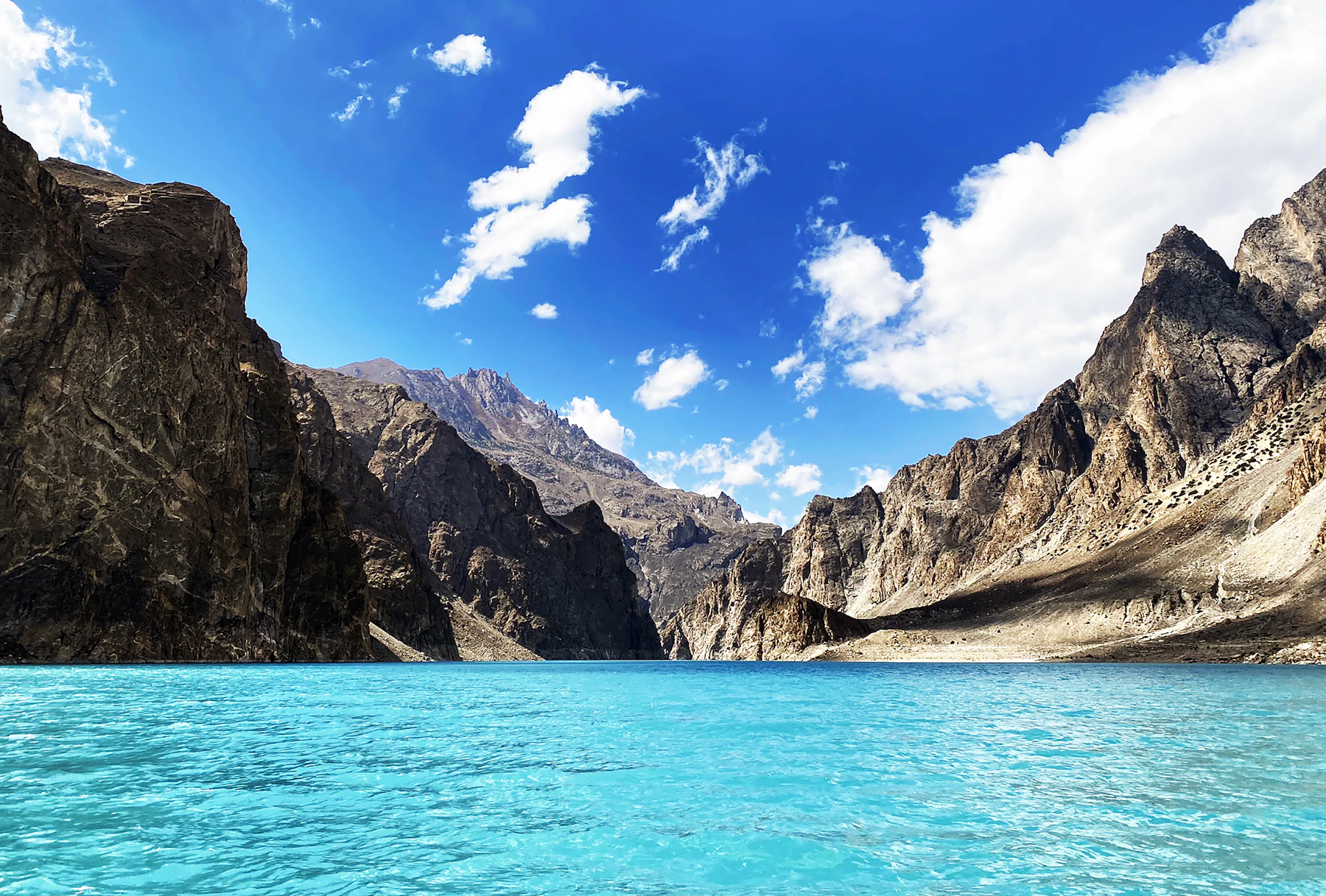 Turquoise alpine lake between steep mountains in northern Pakistan