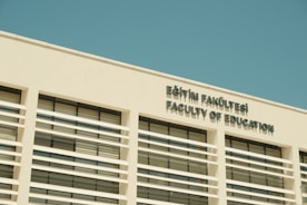 Faculty of education building under a blue sky.