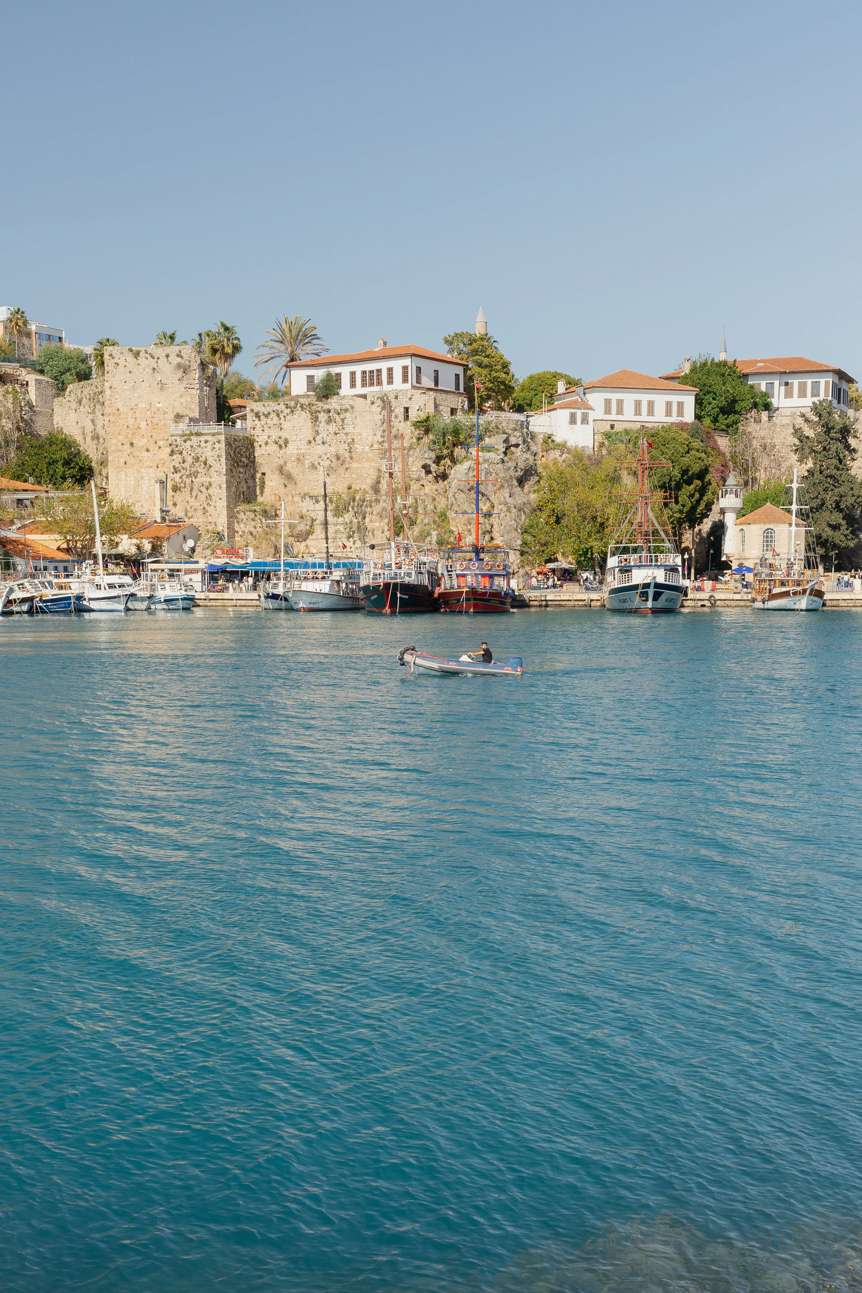 Blue Mediterranean harbor filled with boats in Antalya, Turkey