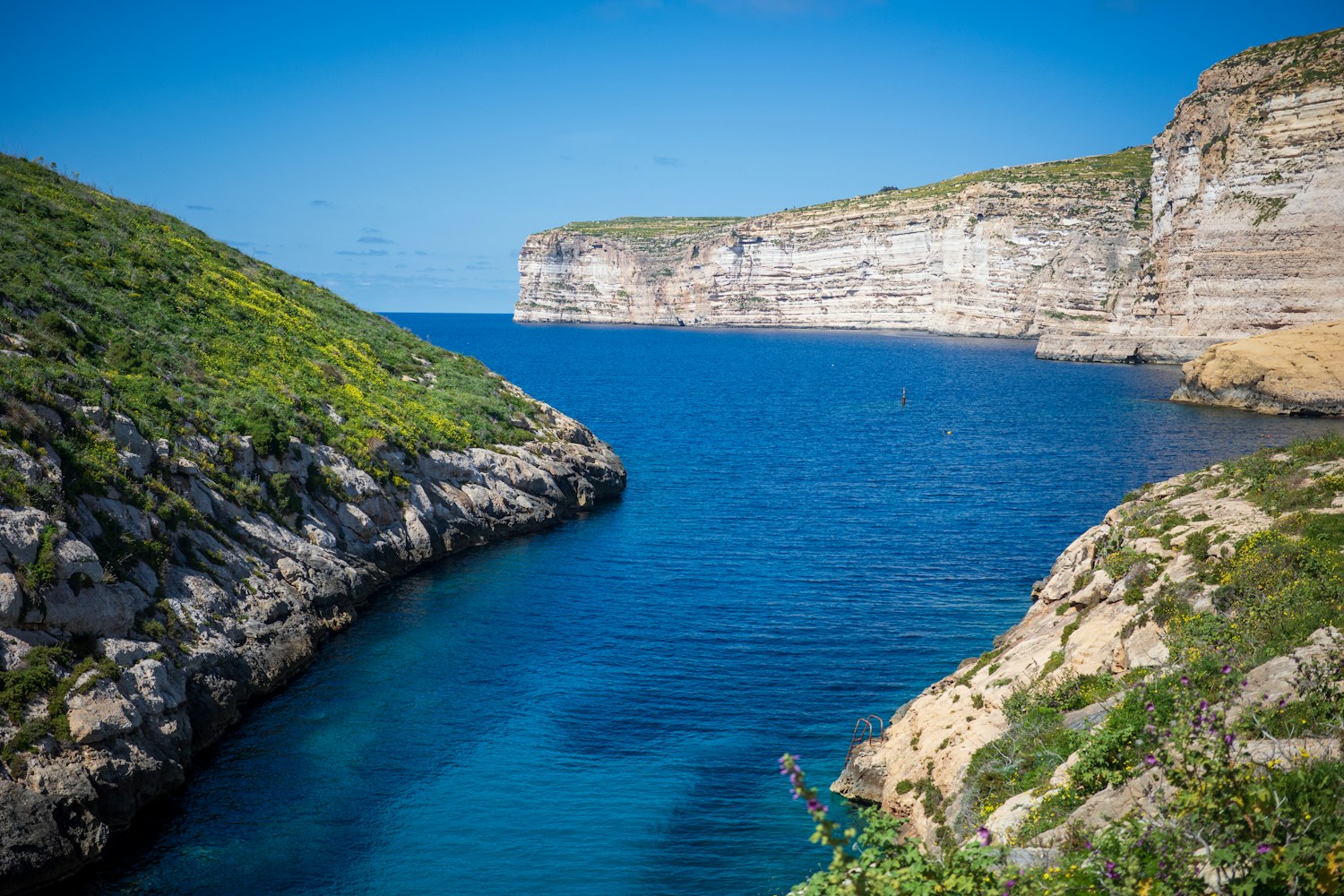 Limestone cliffs and deep blue water on the coast of Gozo