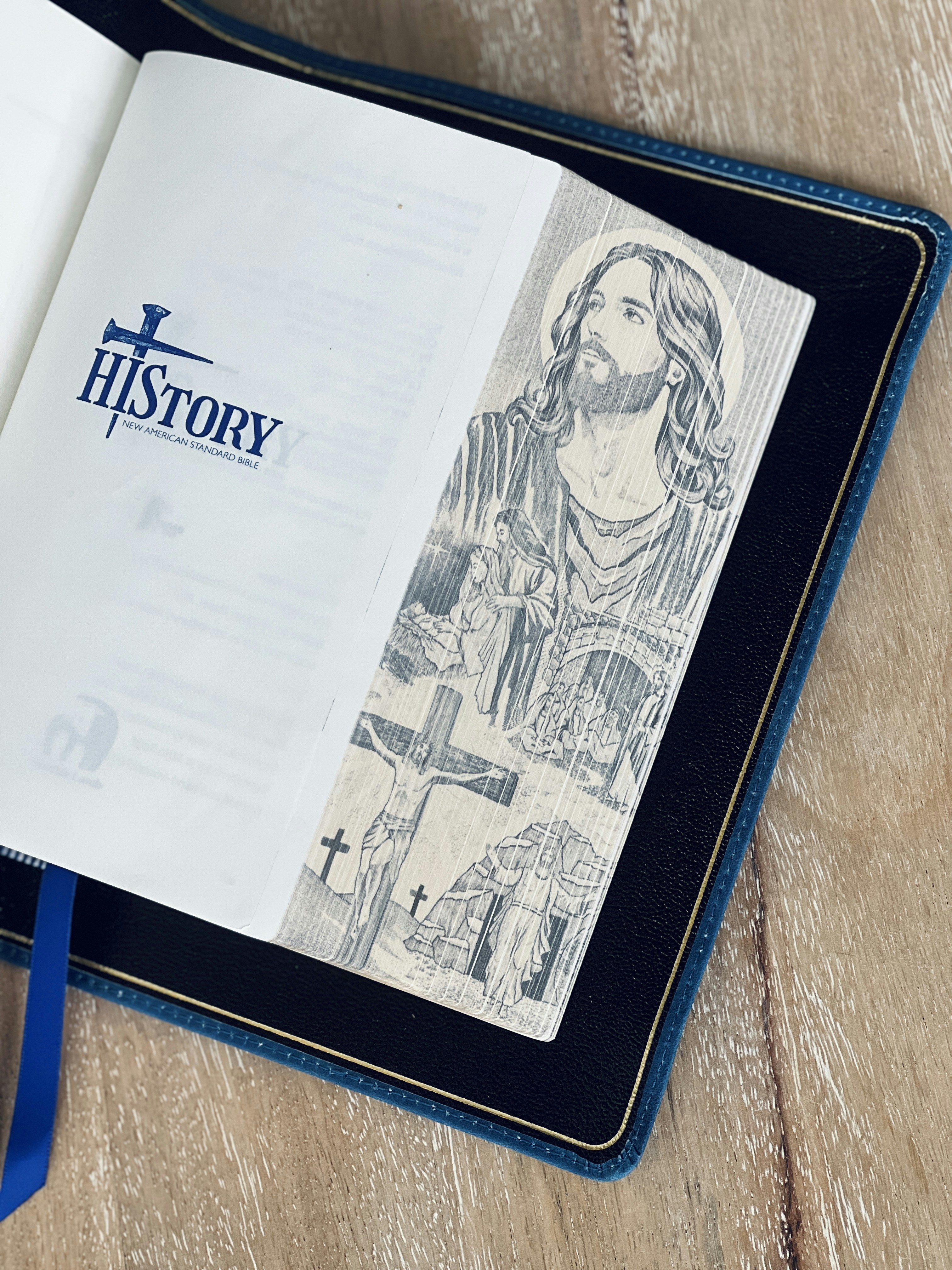 An open bible with a jesus bookmark.