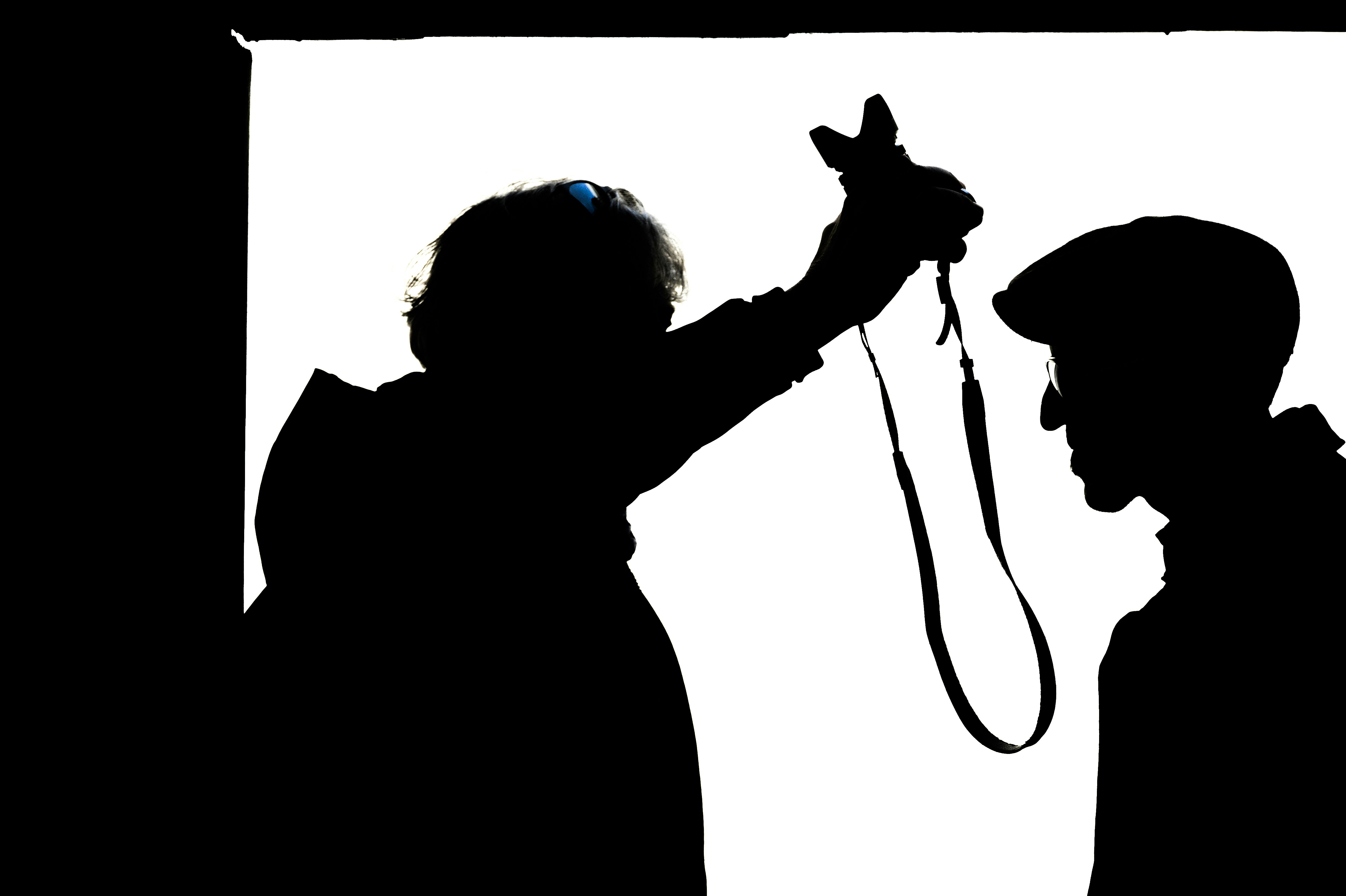 Police officer interviewing a suspect in a well-lit interrogation room.