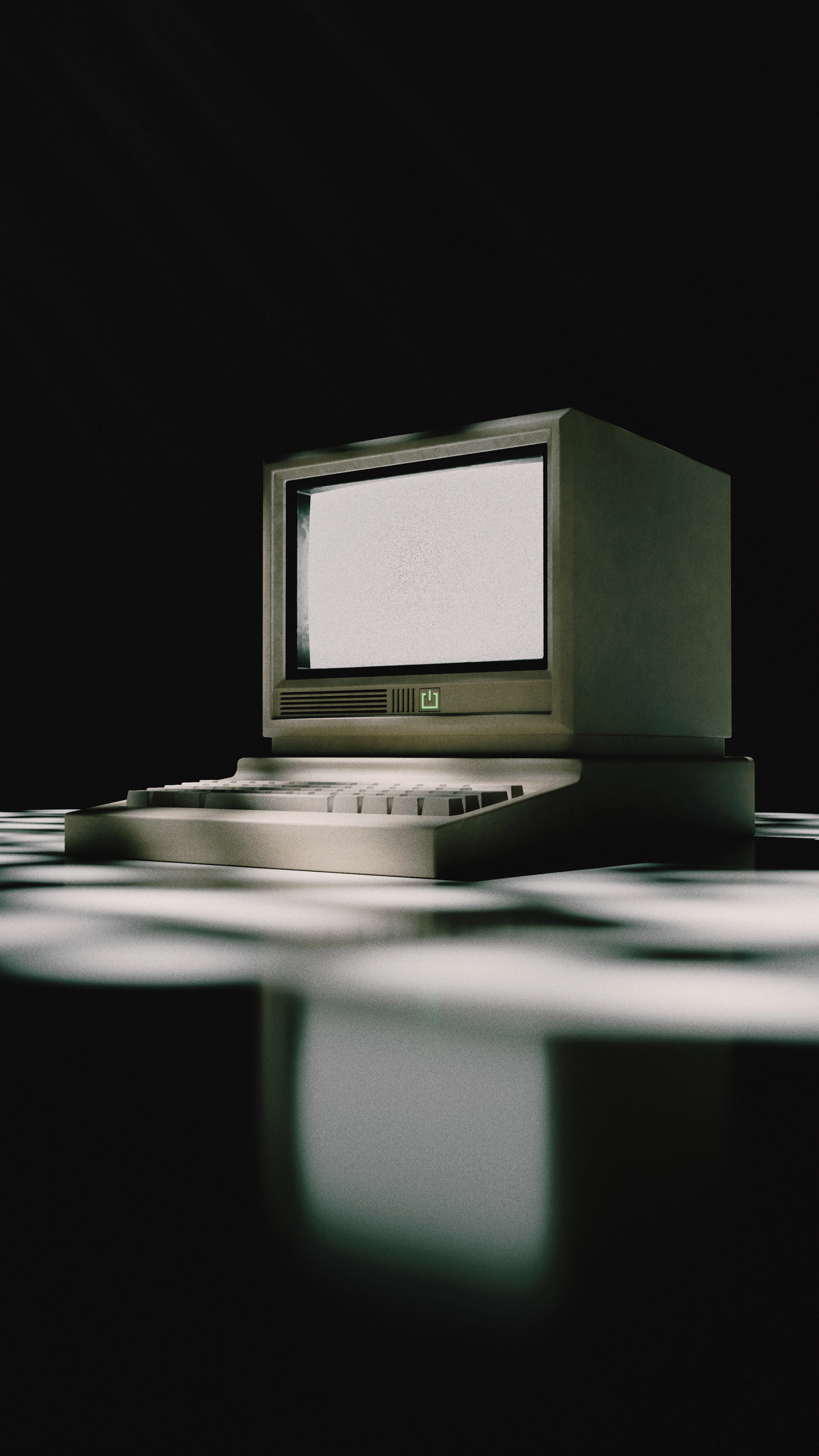 A vintage computer sits on a patterned surface.