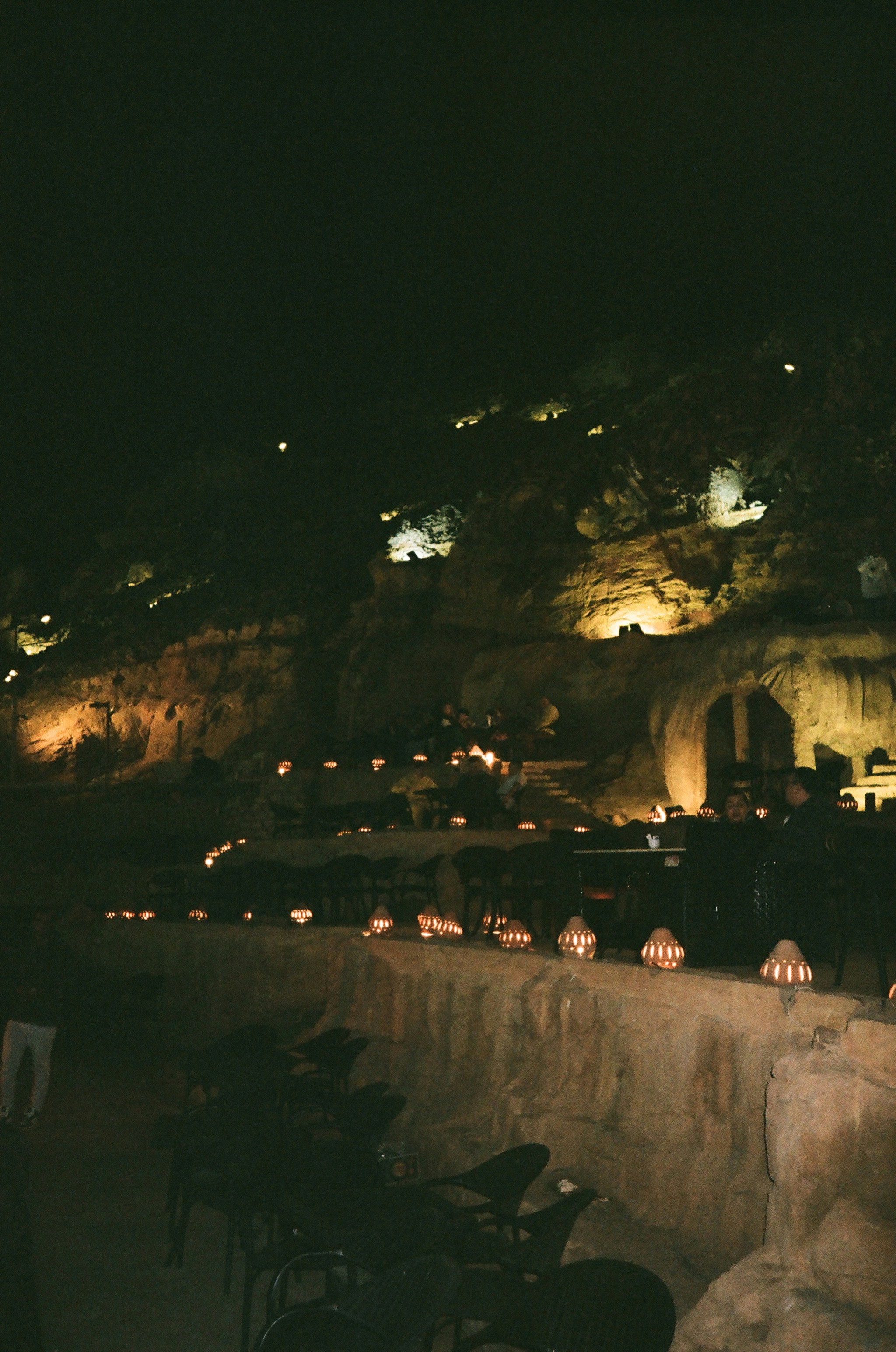 An event is illuminated inside a dark cave