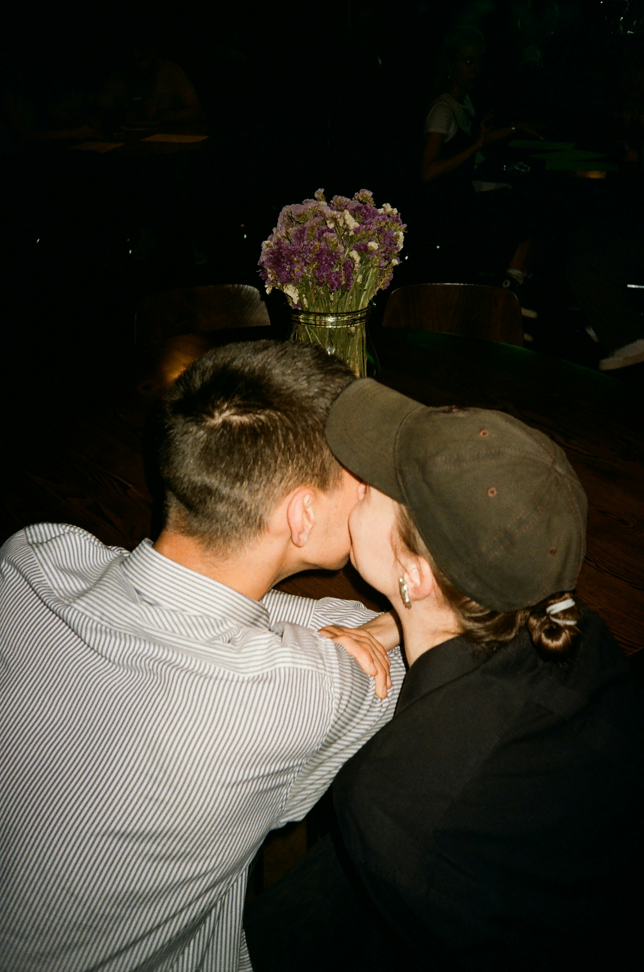 Two people share a tender, romantic kiss