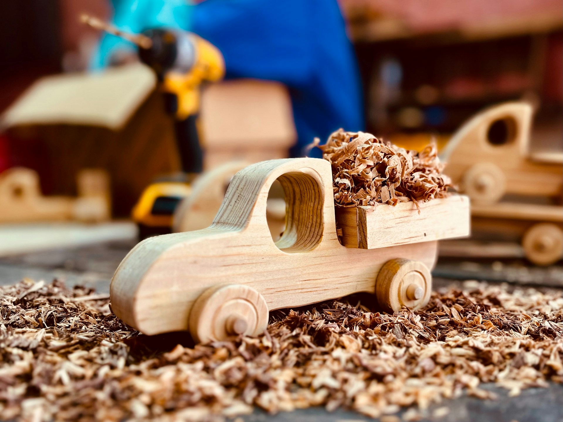 A wooden toy truck filled with sawdust.