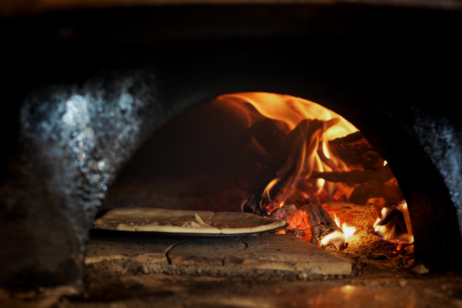 Pizza baking in a wood-fired oven.