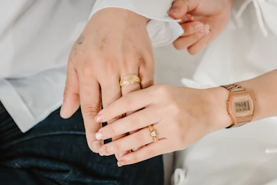 Married couple's hands show off their wedding rings.
