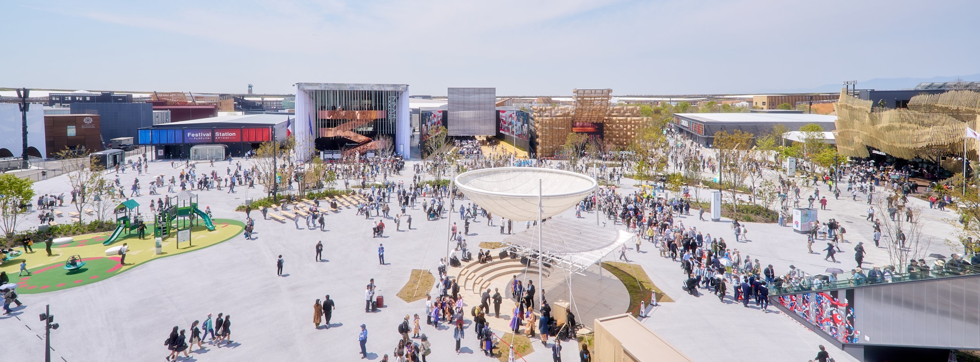 People gather in a busy outdoor plaza.