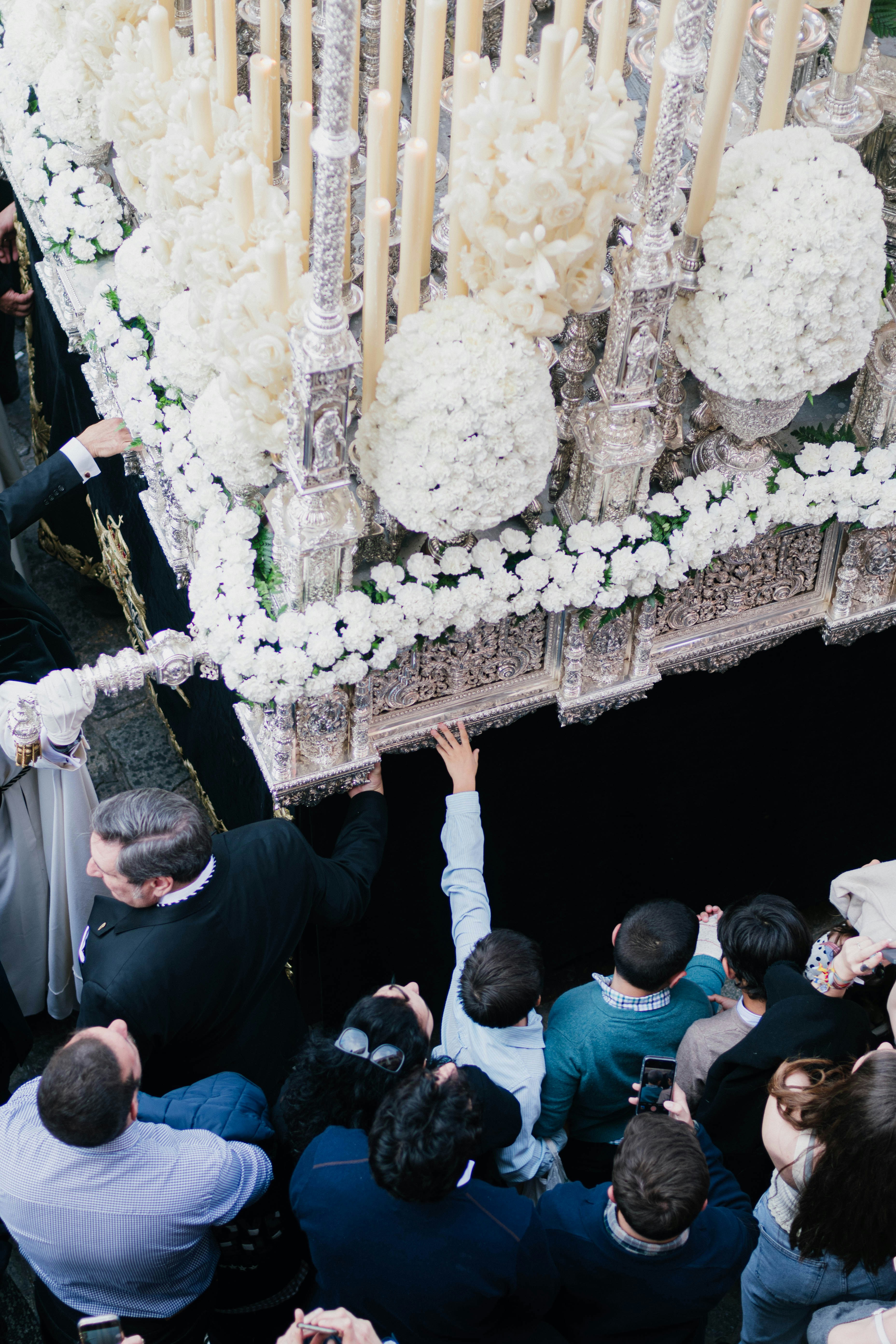 People carry a decorated religious float in a procession.