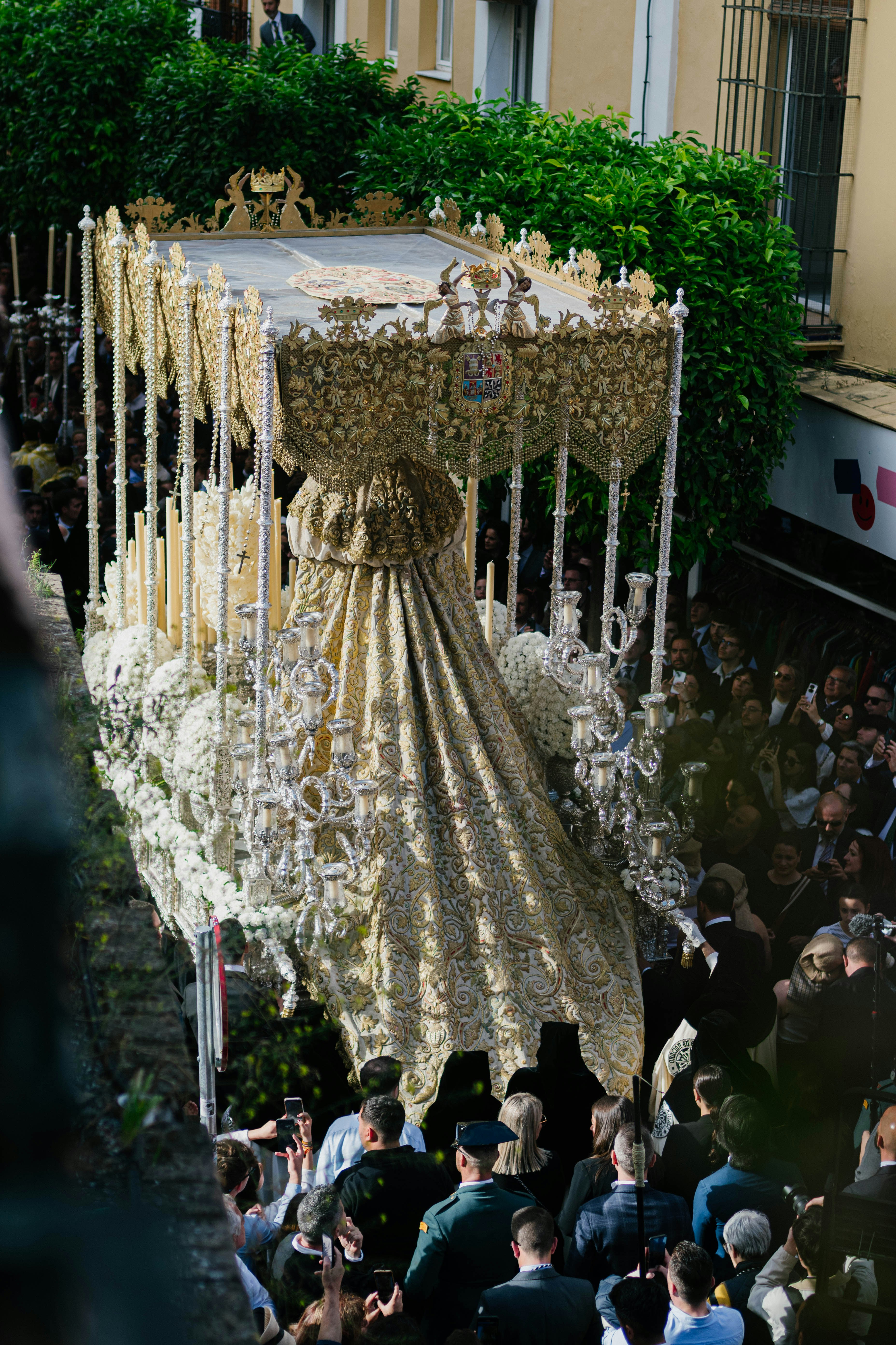 Religious procession with an ornate float.