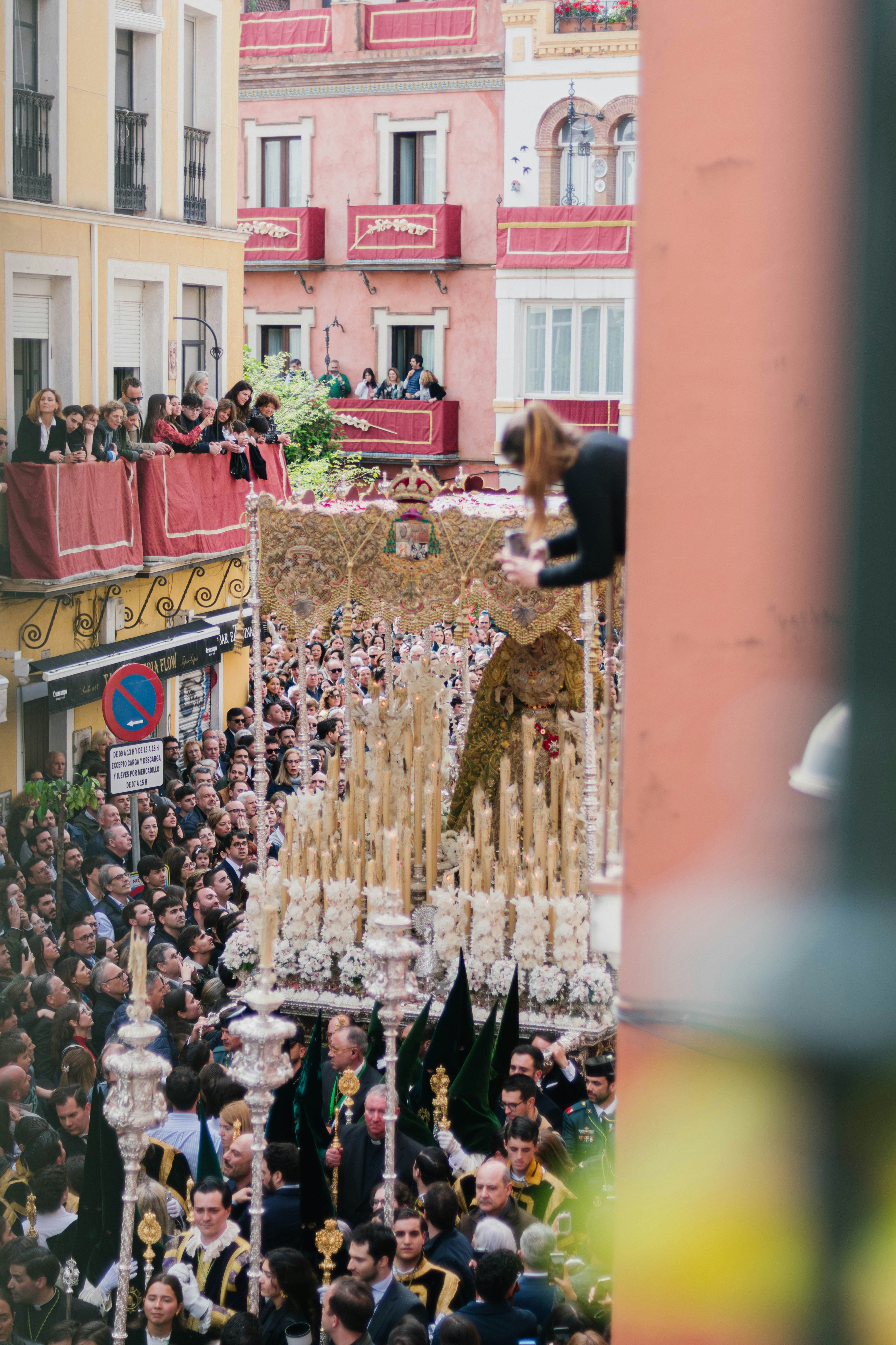 People gather to watch a religious procession.