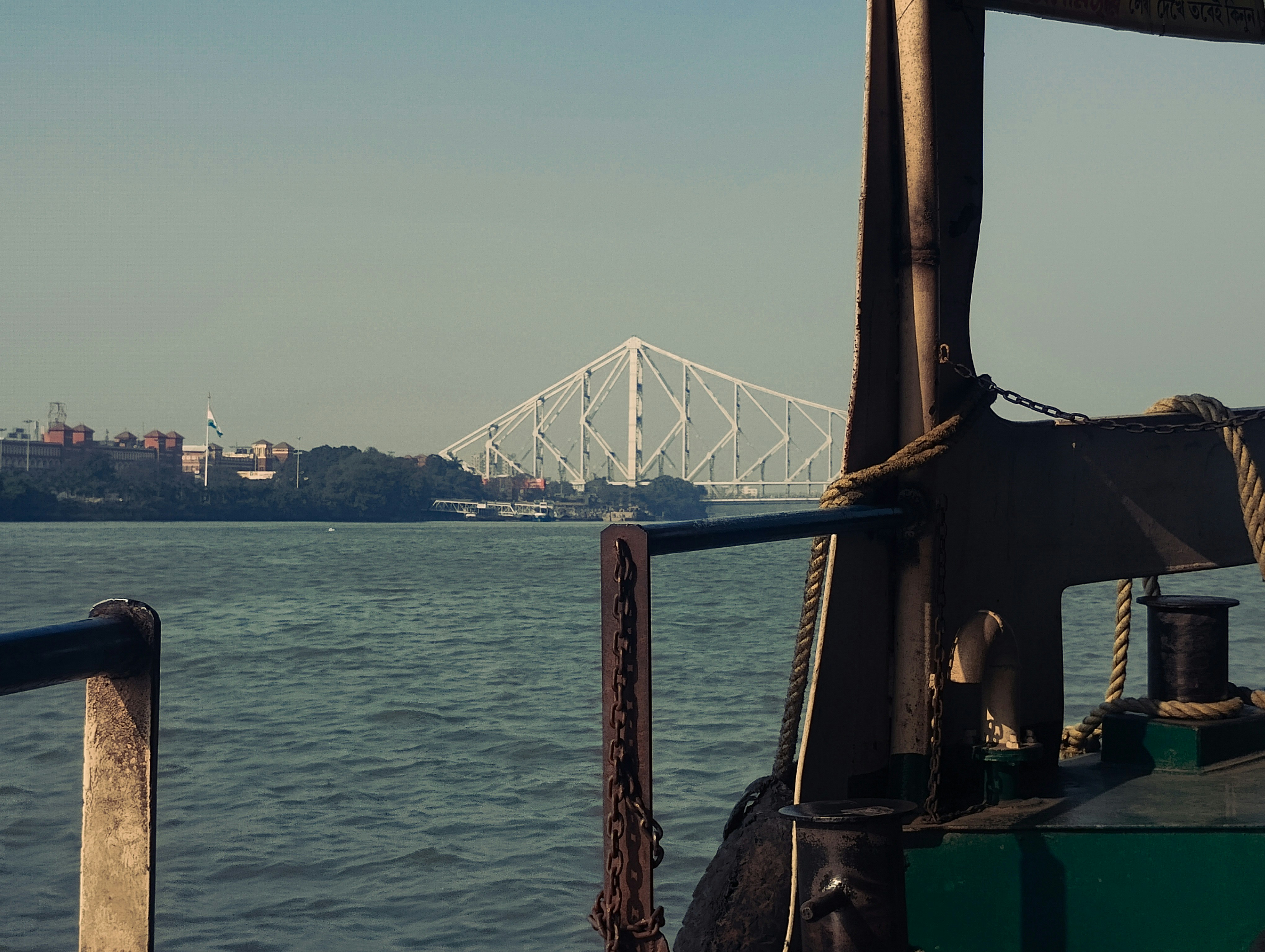 A white bridge spans a wide body of water.