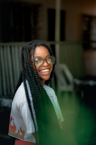 Happy girl smiles and shows off her braids.