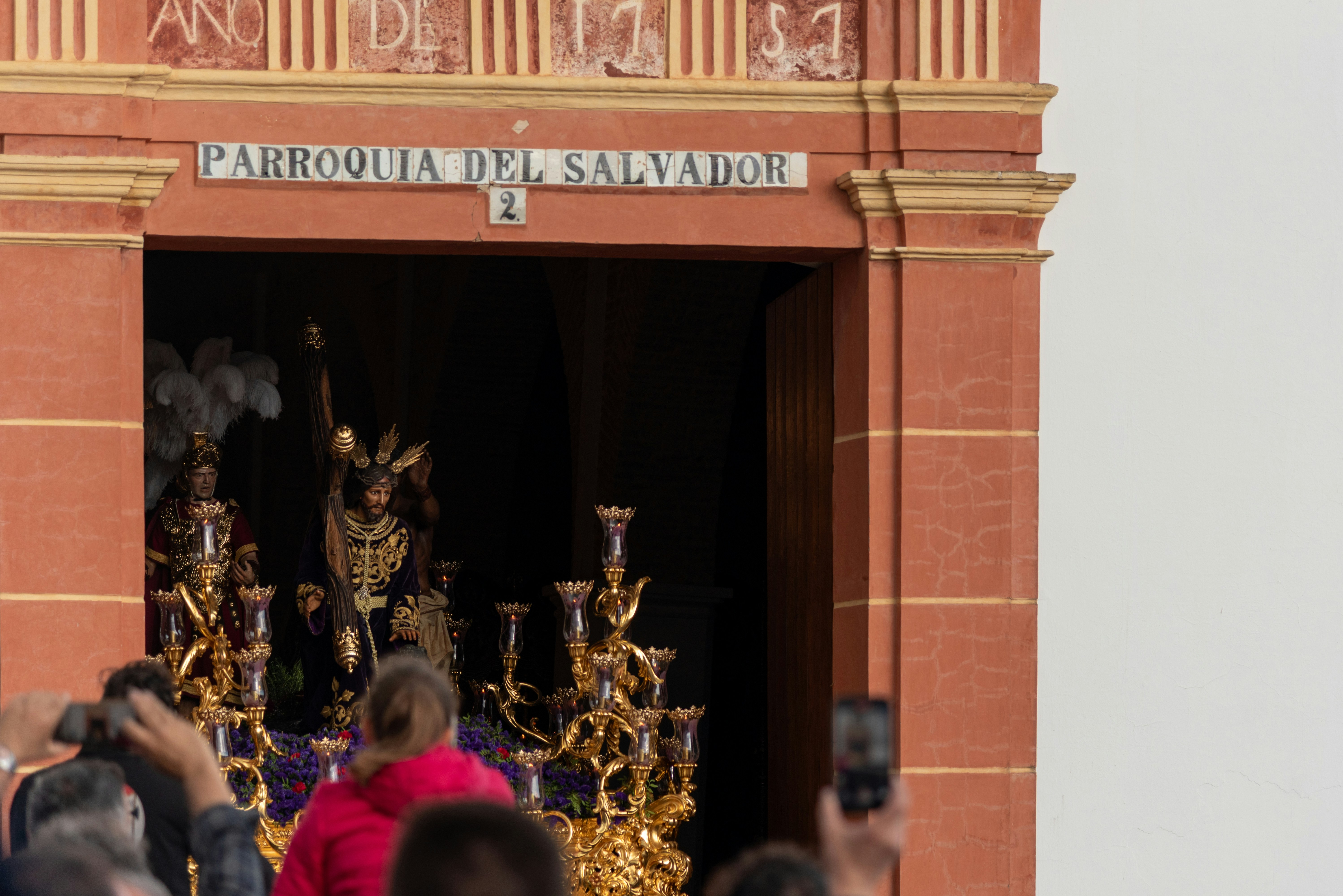 People watching a religious parade inside the church.