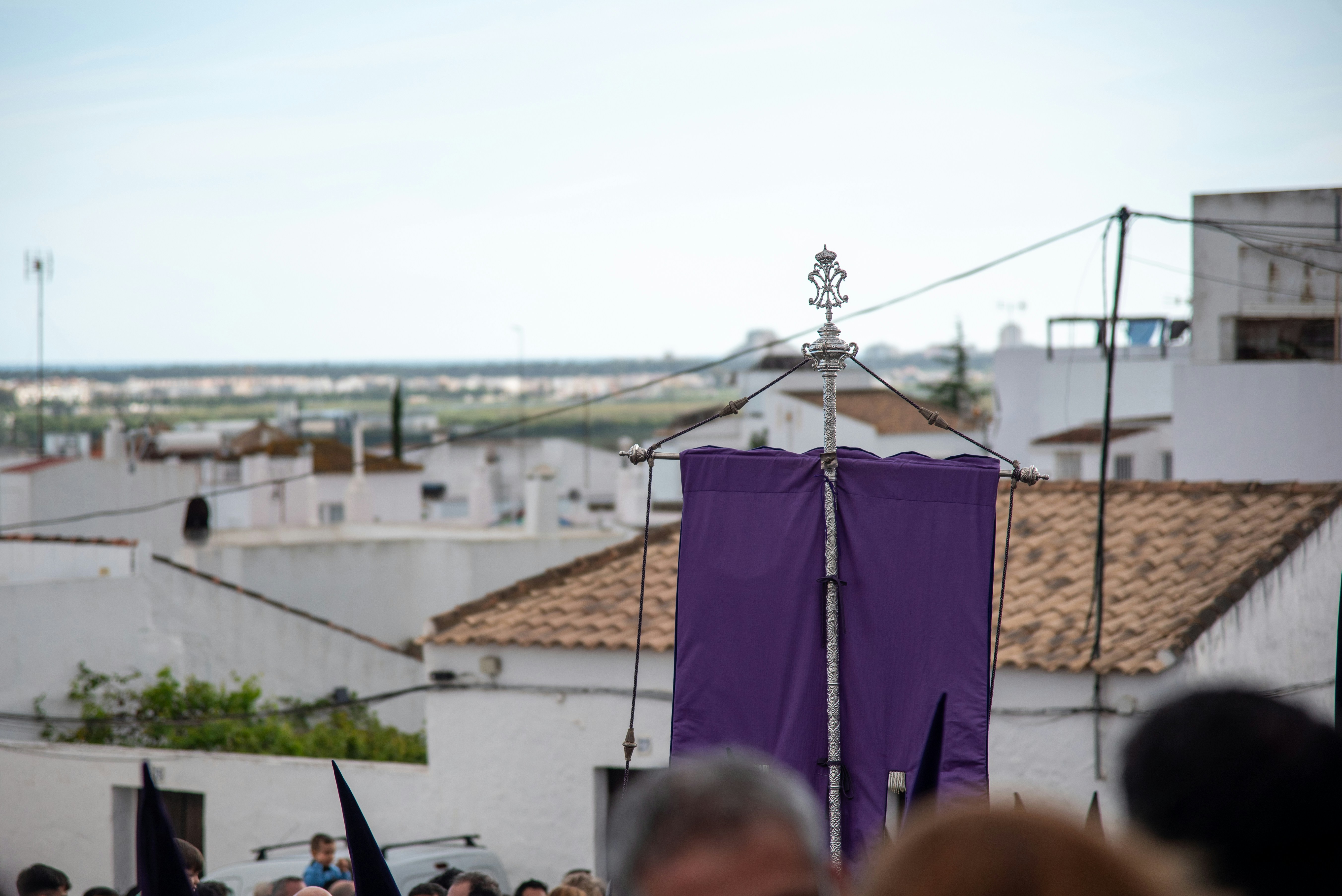 A purple banner stands over white buildings.