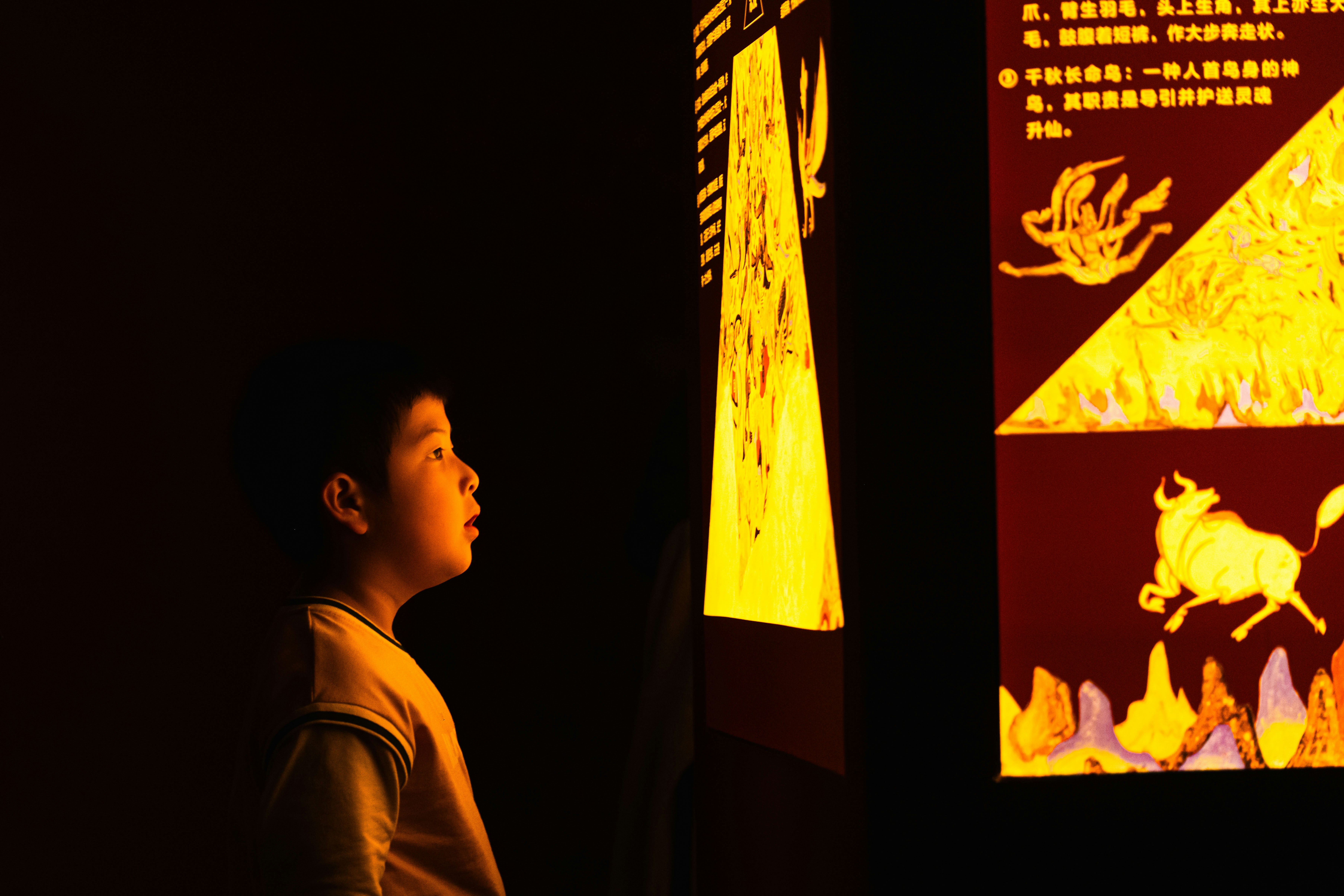 A child gazes at a lit up display.