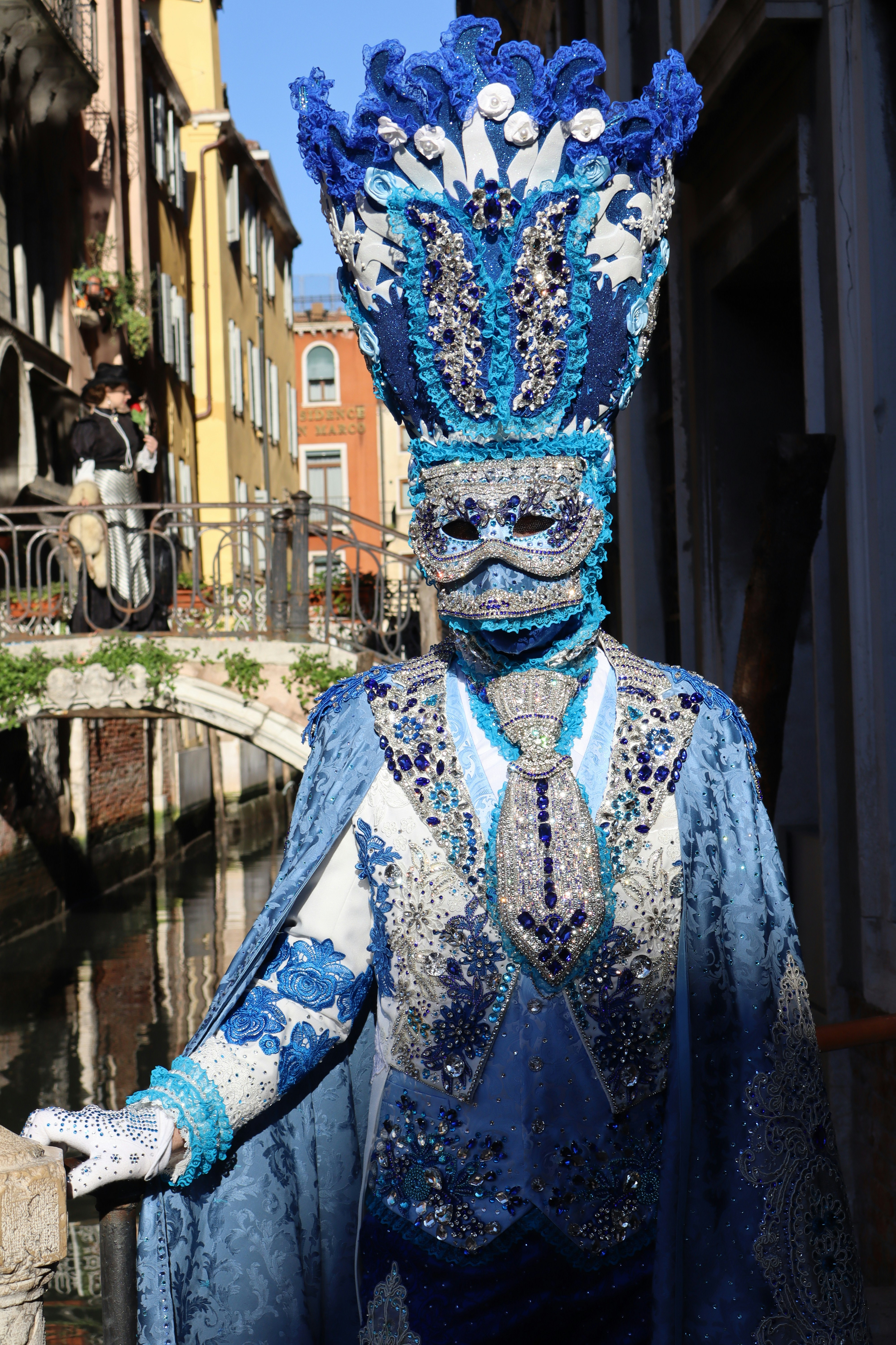 A person in a carnival costume poses.