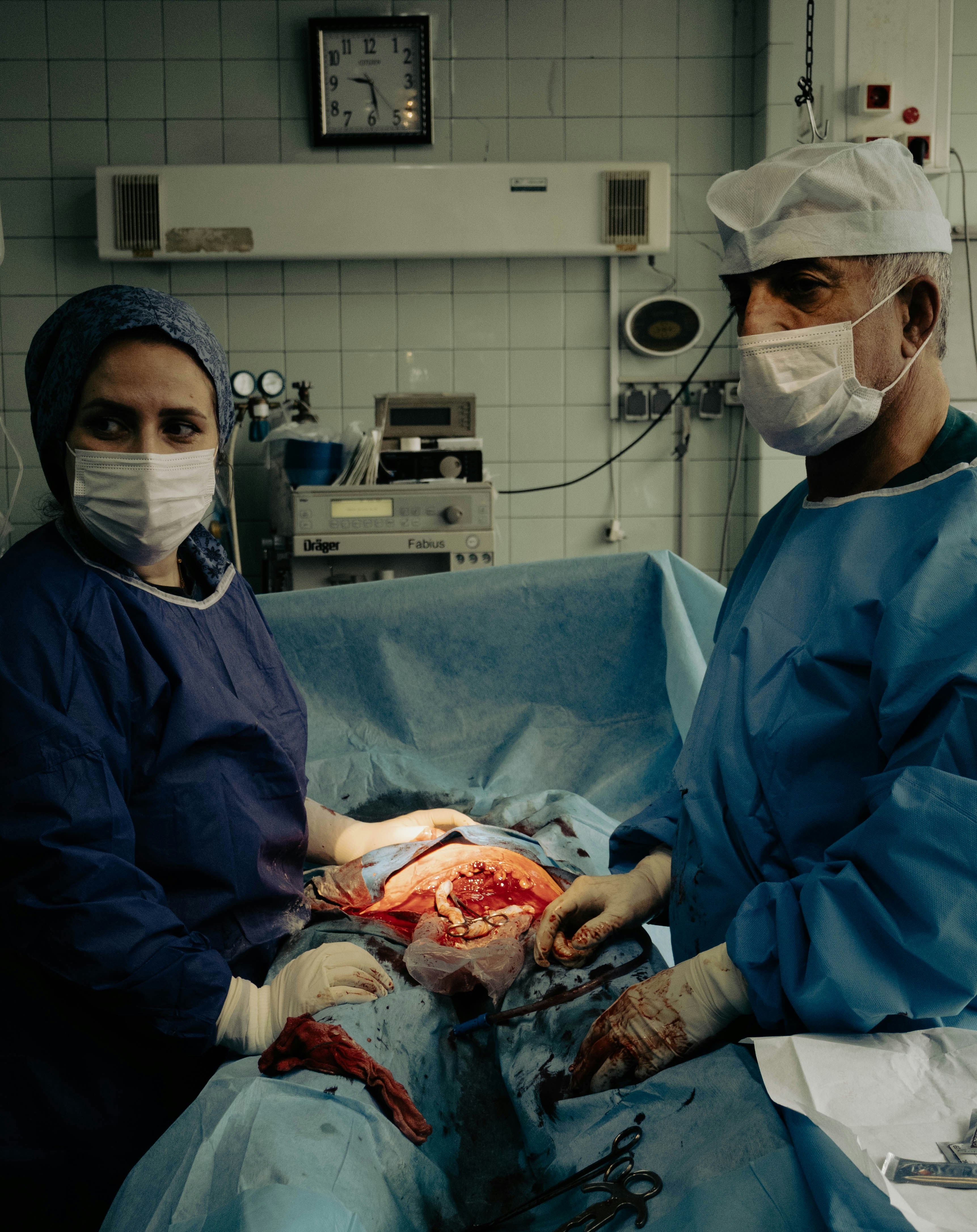Surgeons perform an operation in a sterile operating room.