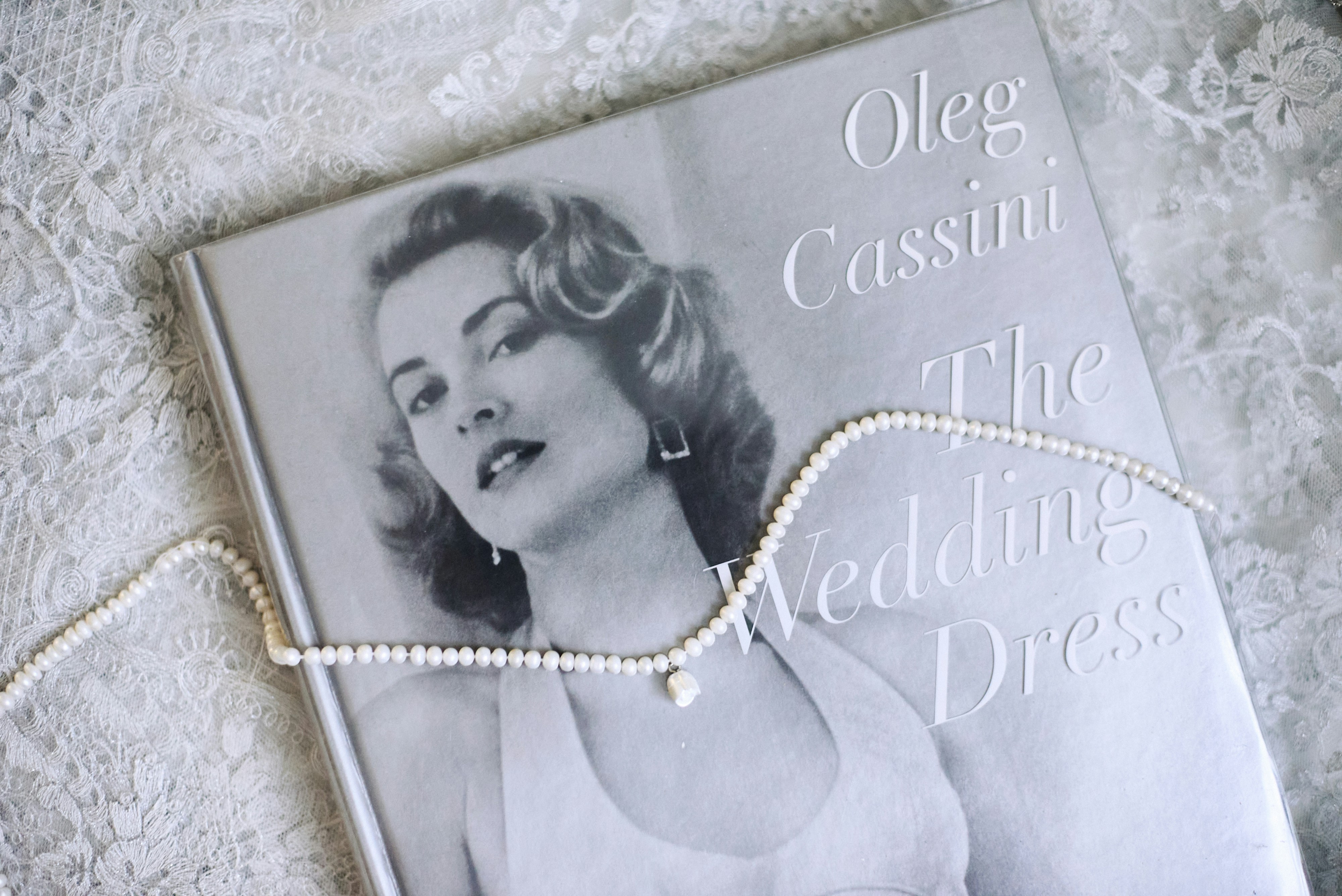 Book and pearls on lace with a vintage vibe.