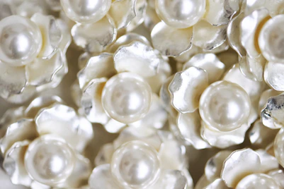 White flowers with pearl centers fill the frame