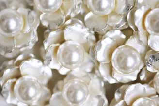 White flowers with pearl centers fill the frame.