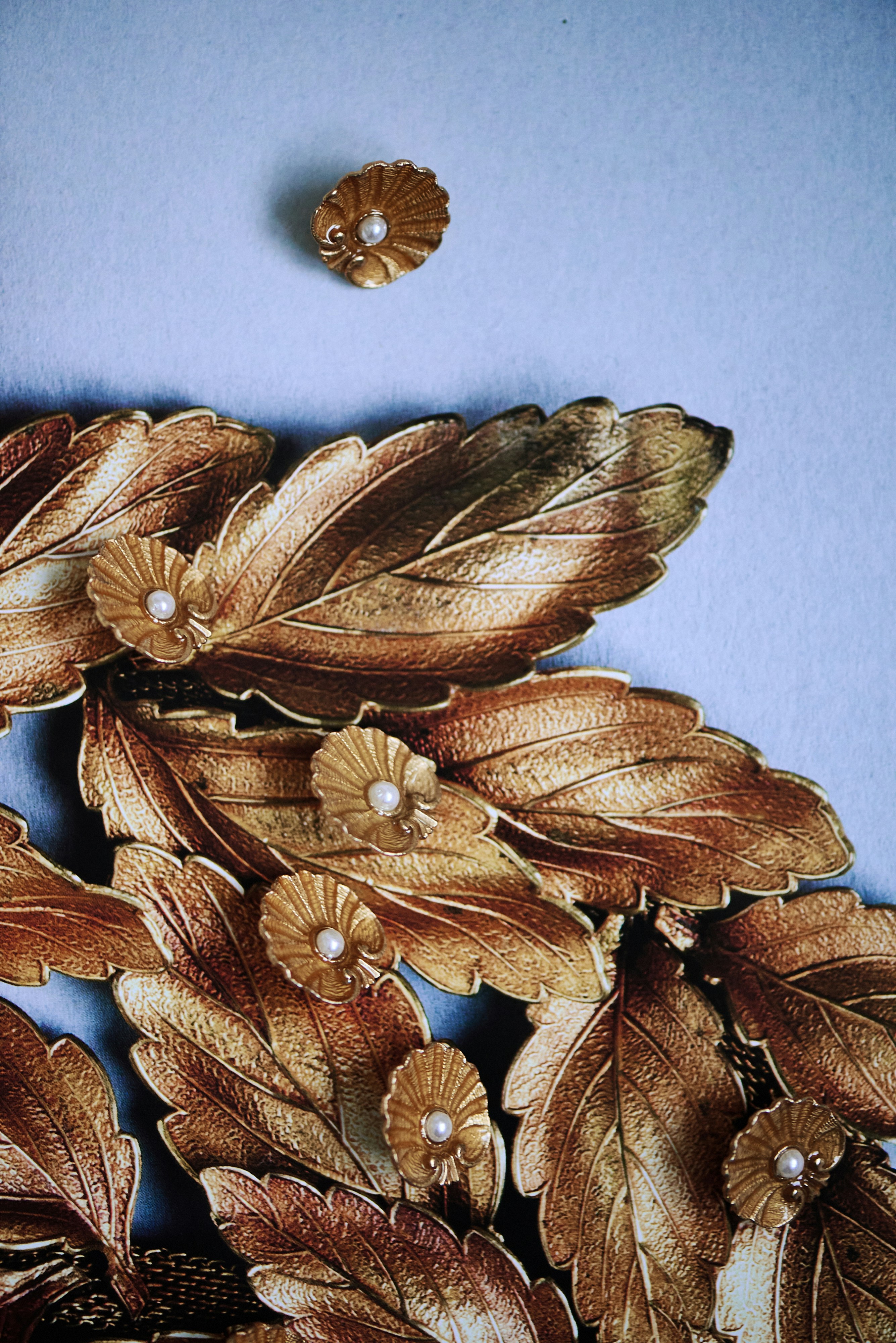Golden leaves and small flower ornaments are visible.