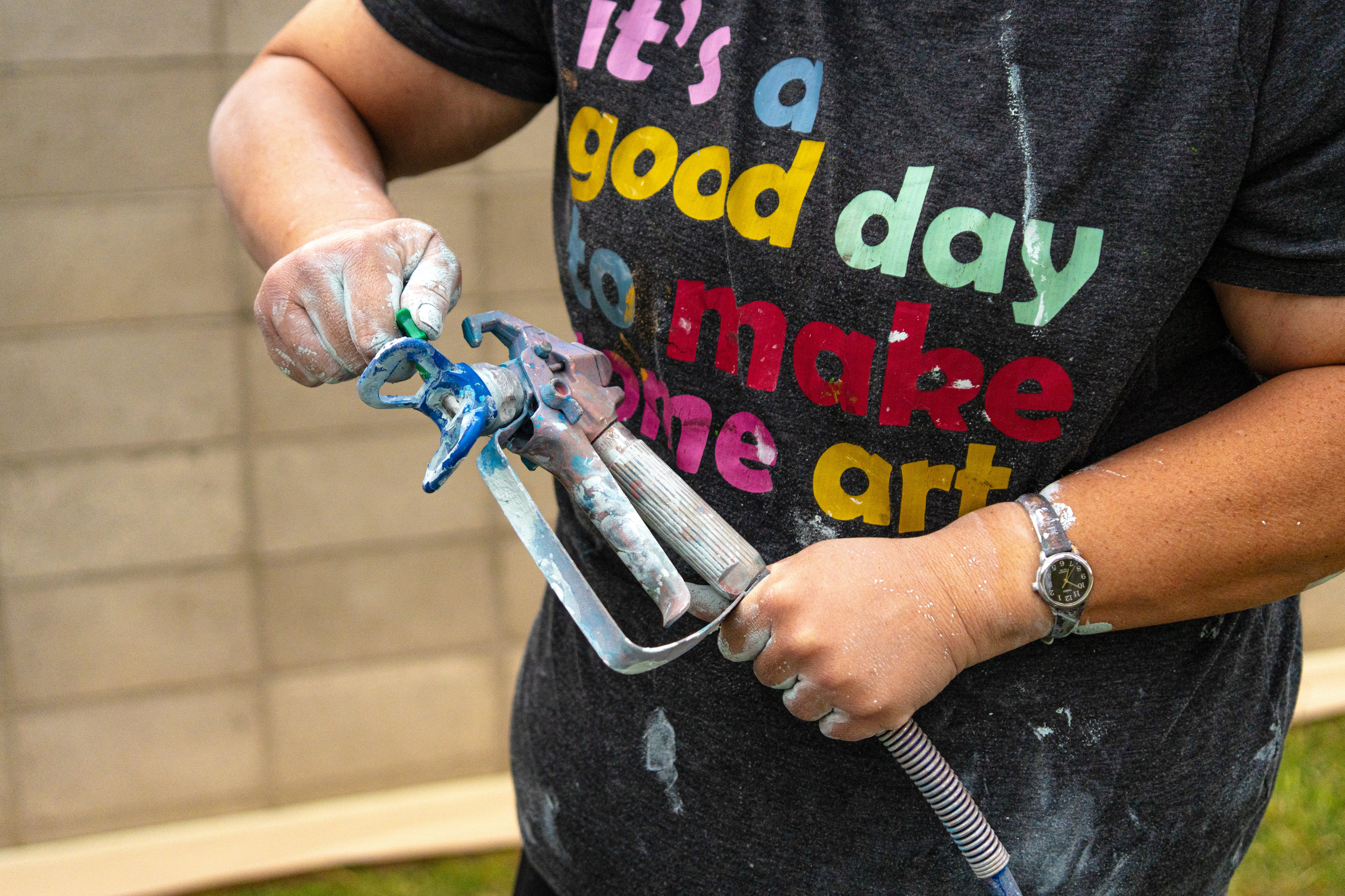 Holding an HVLP paint sprayer gun before spraying a project