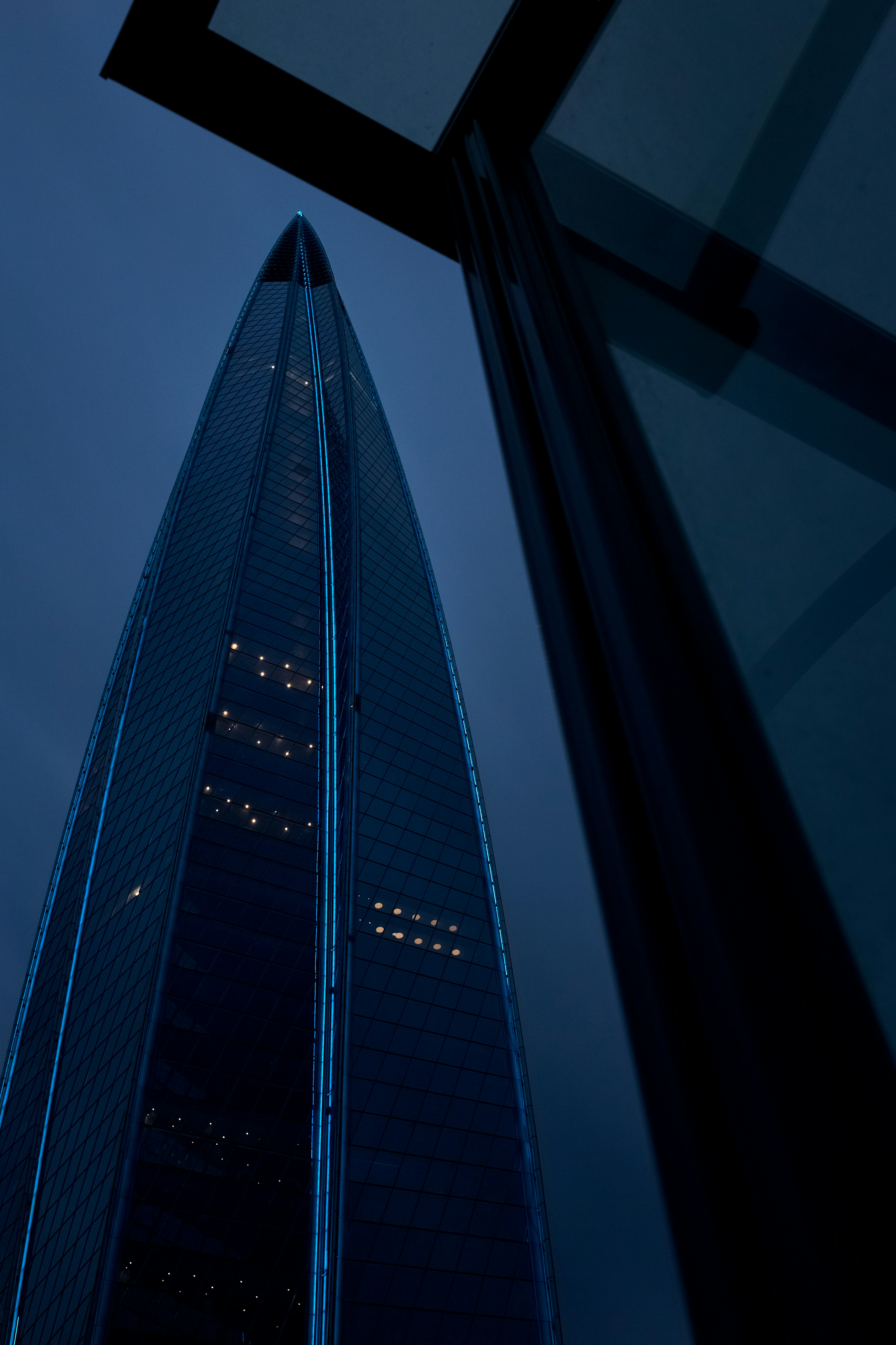 A tall building reaches into the dark sky.