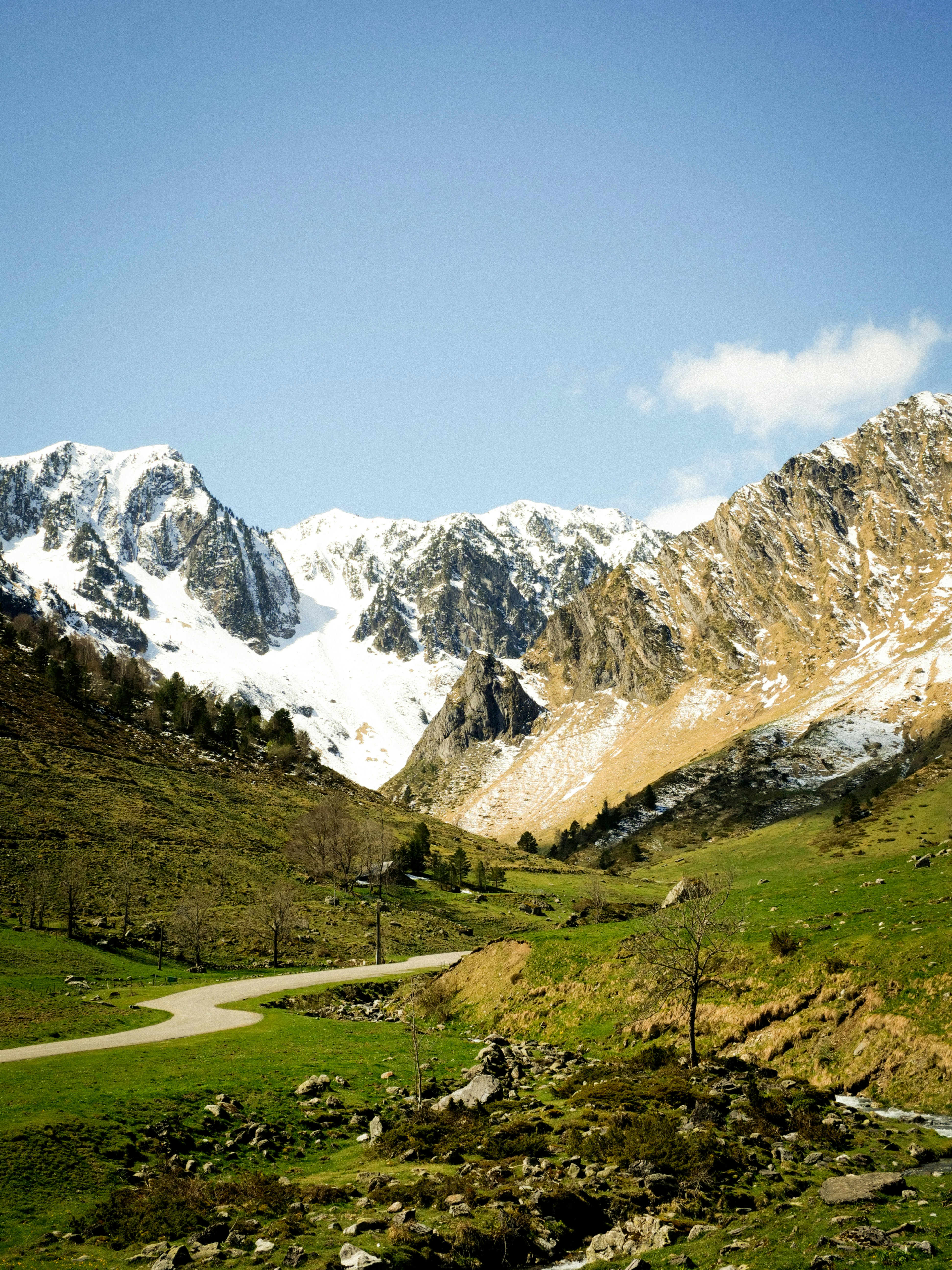 Snow-capped mountains and a winding road.