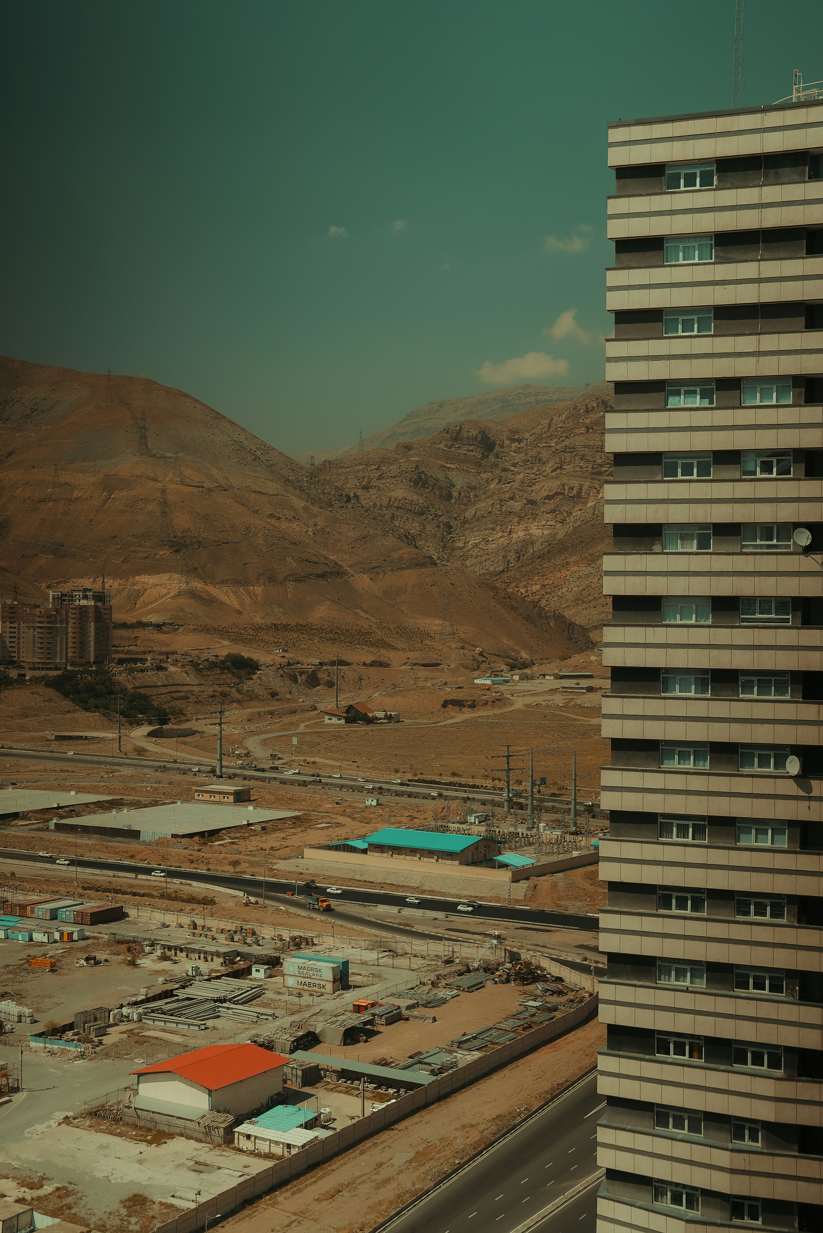 Building and mountains are visible in this landscape.