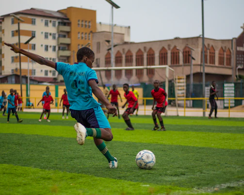 Soccer players are playing a match on a field.