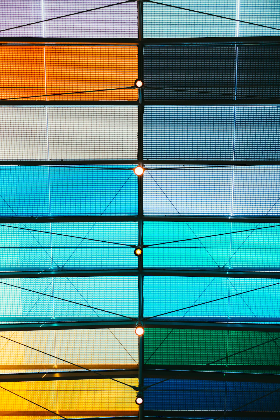 Colorful glass panels forming a geometric ceiling