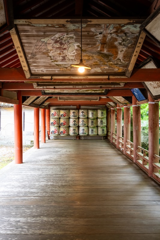 Long wooden corridor in traditional Japanese architecture showing post-and-beam construction and polished wooden floors
